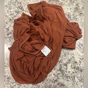 Rust colored Lou Lou and company swaddle blanket
